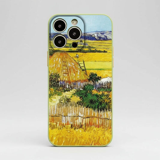 Phone case with a design of a field and haystacks, inspired by Van Gogh's artwork, on a gray background.